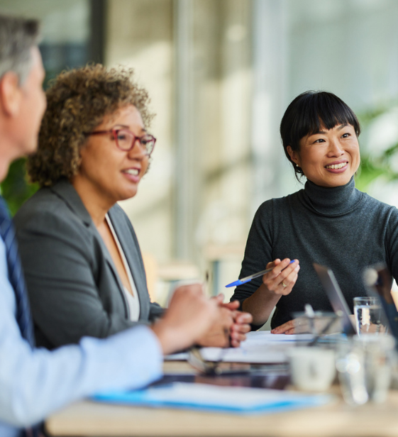 Employees in a meeting discussing their well-being solution needs