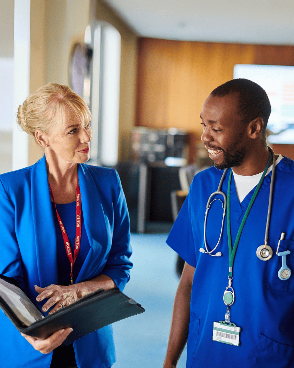 Traveling medical sales professional connecting with a doctor in a healthcare setting.