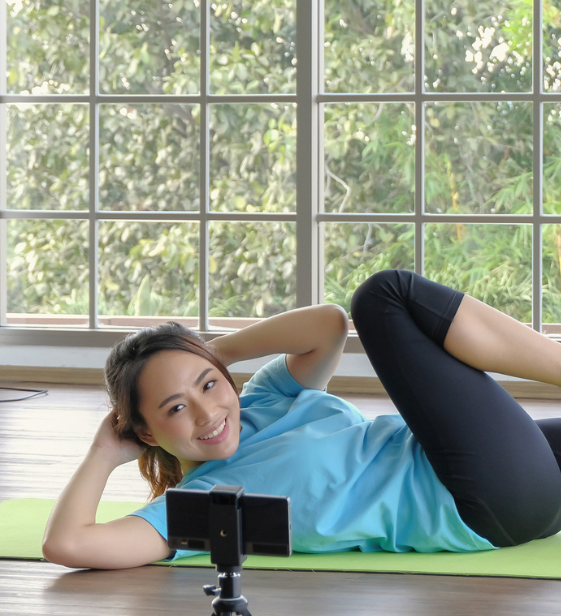 Woman following a virtual workout on the Exos app at home — showing how Exos brings coaching to a global, remote workforce.