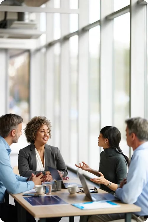 Business team in discussion, symbolizing Exos and Pfizer’s global well-being partnership at scale. Business team in discussion, symbolizing Exos and Pfizer’s global well-being partnership at scale.